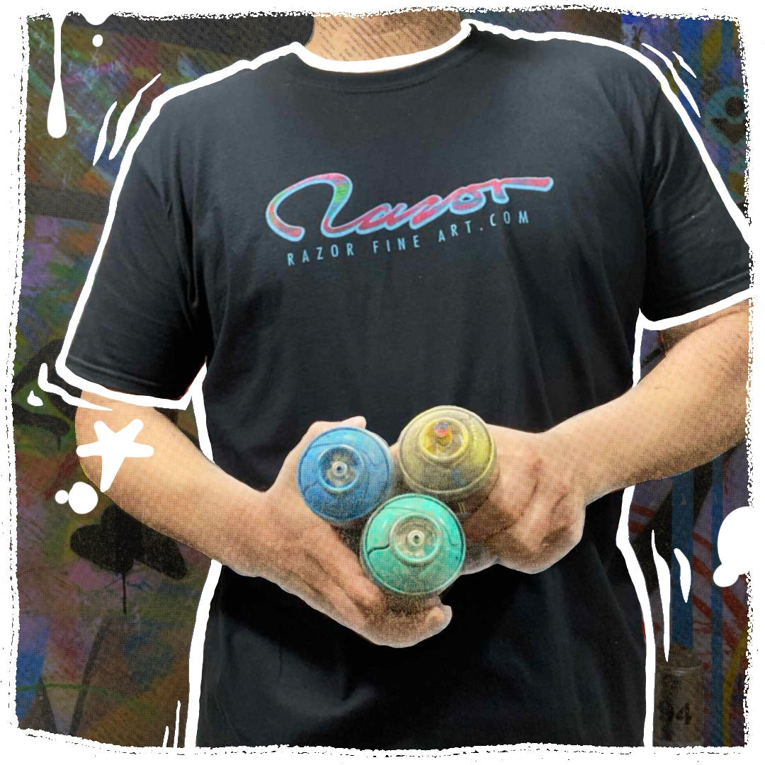 Figure wearing Razor fine art dot com shirt and holding spray cans in the studio