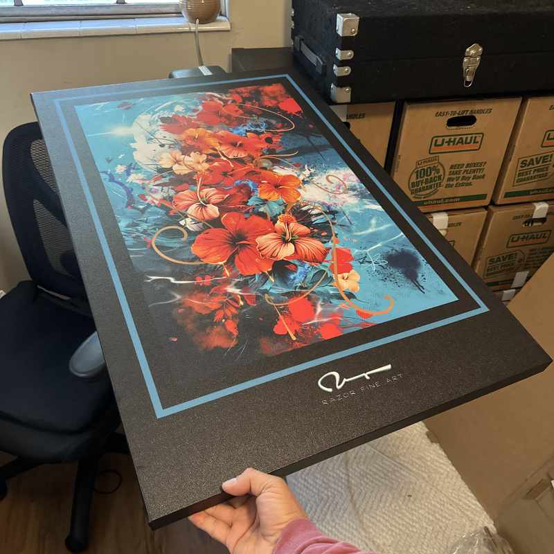 Artwork being held by my hand across an office chair for scale.