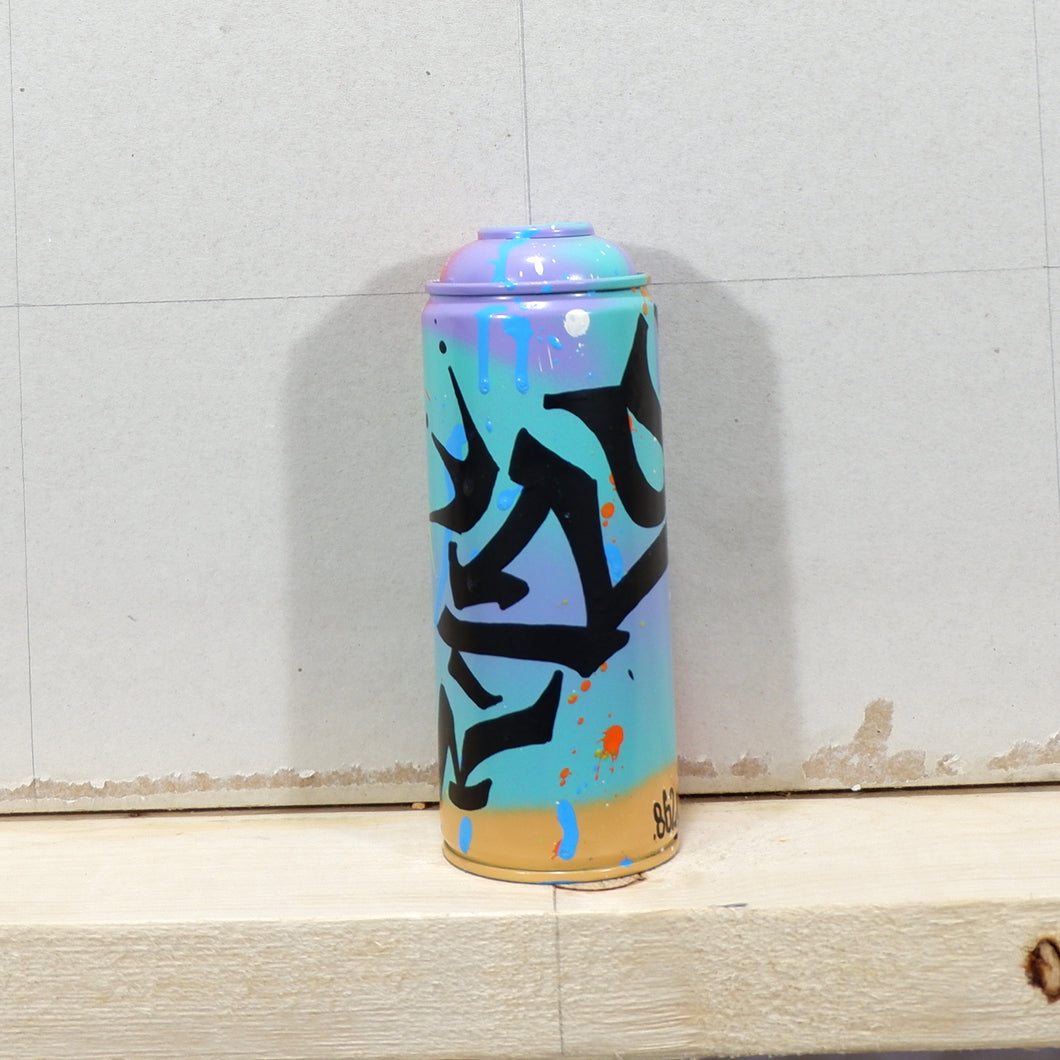 Spent spray paint can painted with abstract graffiti